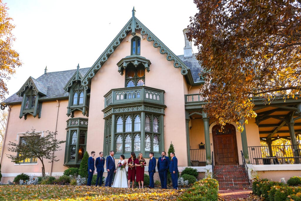 Bridal party outside Fowler House Mansion on a fall day
